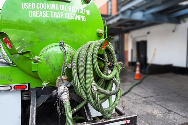 a grease trap being pumped by a sanitation technician in Maplewood OH